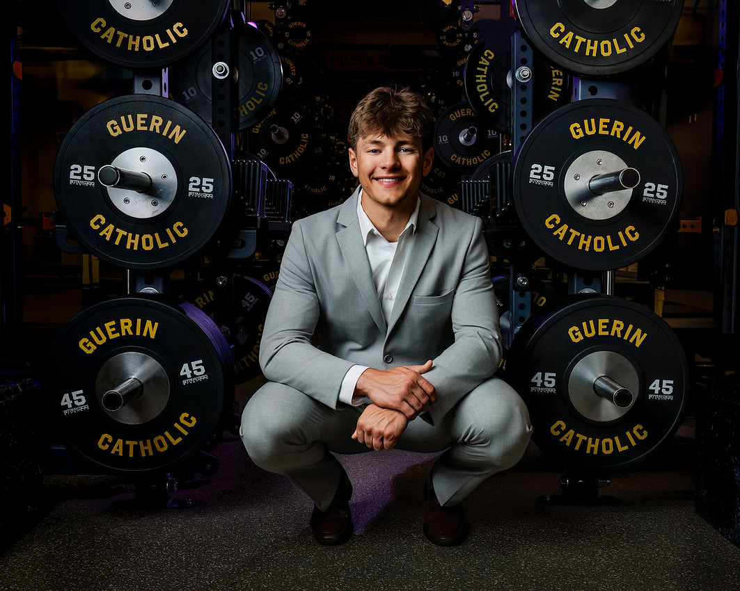 Guerin Catholic senior photographed in a suit inside the school weight room by Fallin Photography
