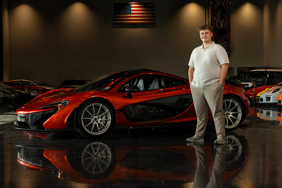 Senior guy photographed with an exotic car during a personalized senior portrait session in Central Indiana
